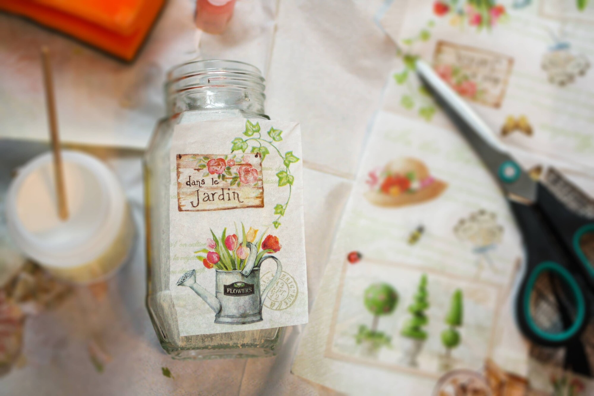 Glass jar with floral decoupage design